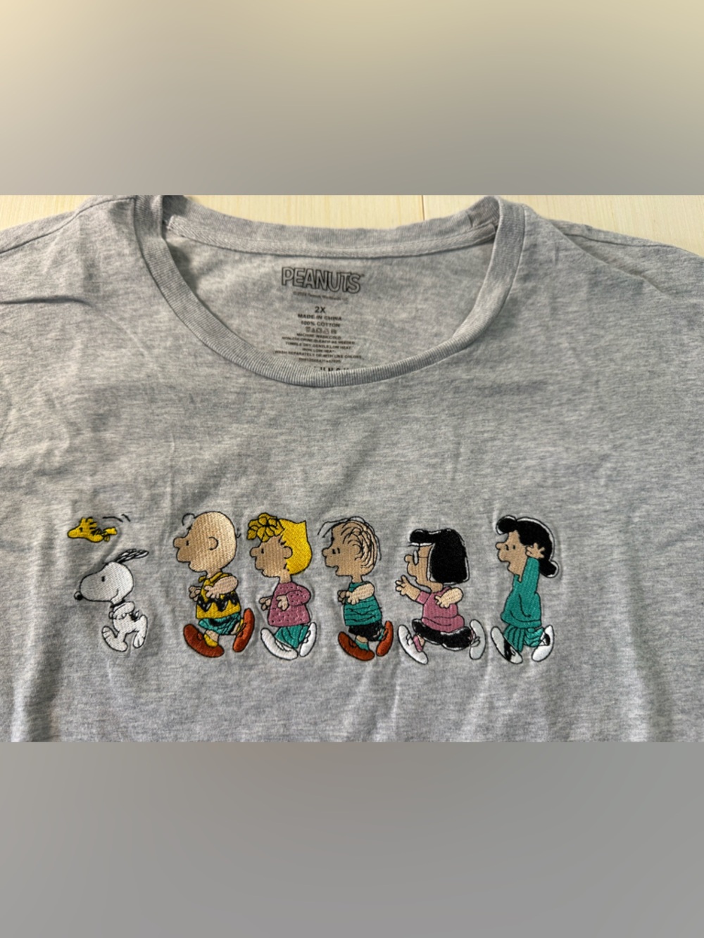 Peanuts Women's Embroidered Graphic T-Shirt with Snoopy’s Gang
